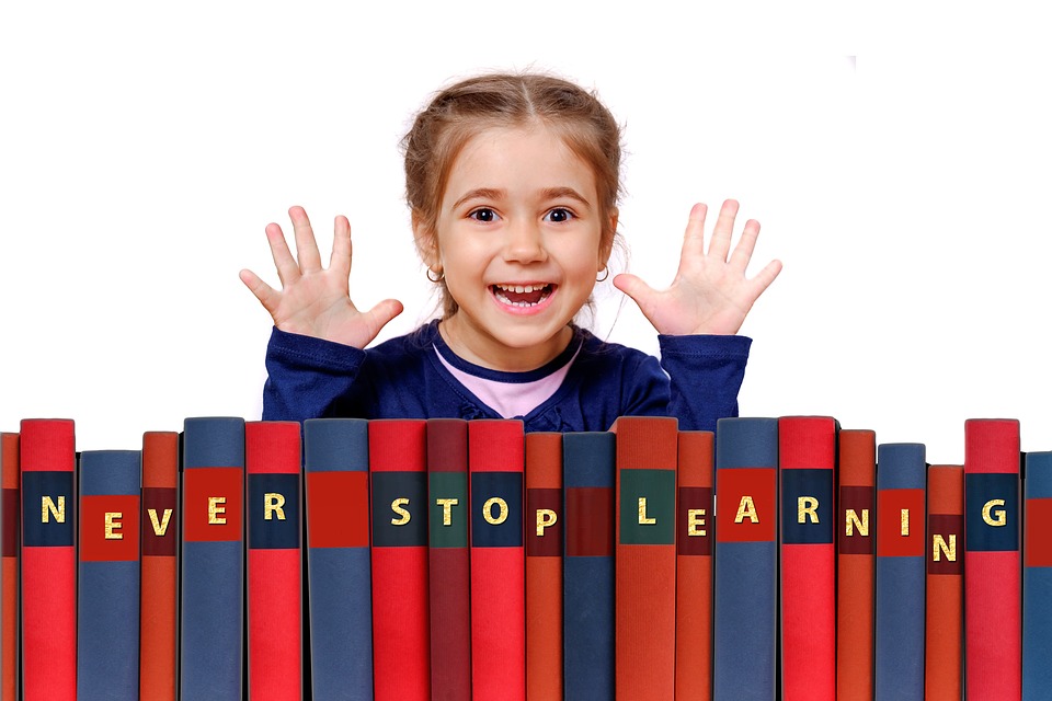 Girl posing behind never stop learning books Girl posing behind never stop learning books