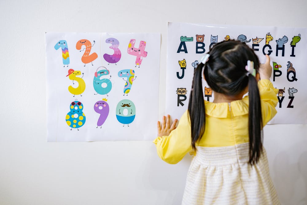 girl learning letters