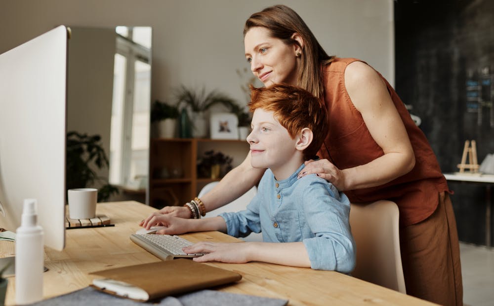 mum helping son on computer