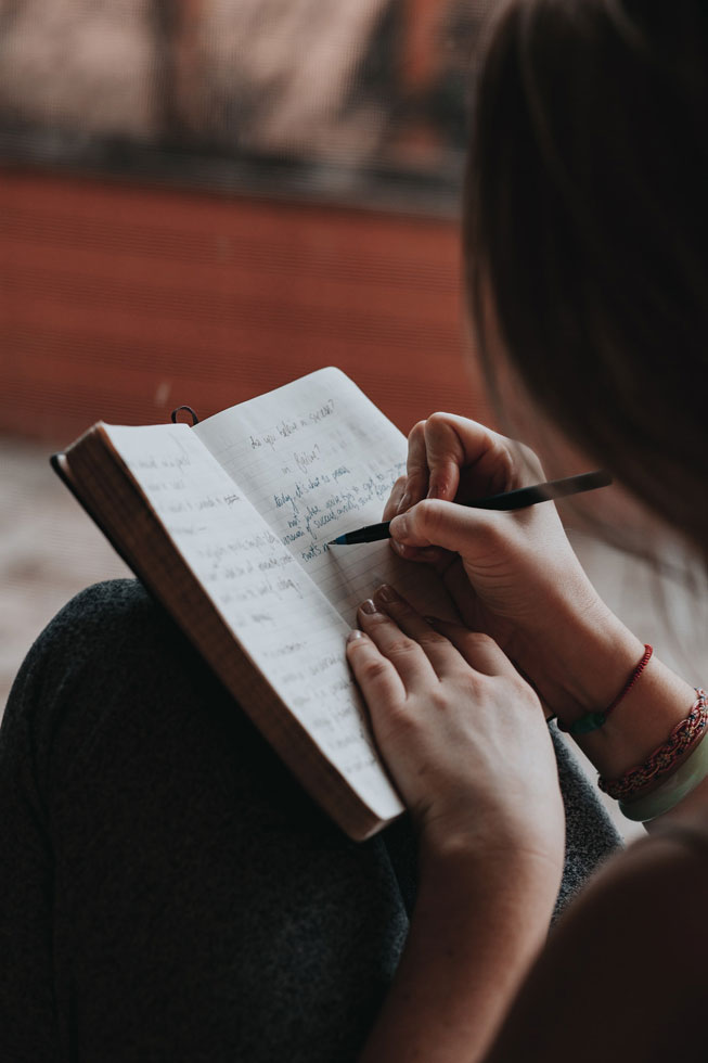 girl writing in notebook