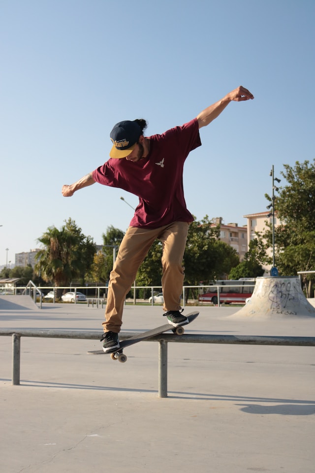 Outdoor activities for mental health. Male teen in t-shirt and khakis balancing on a skateboard Outdoor activities for mental health. Male teen in t-shirt and khakis balancing on a skateboard