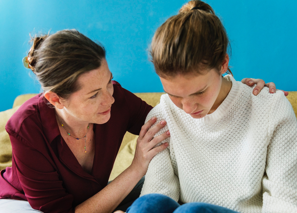 Supportive parent encouraging stressed teen during exam season